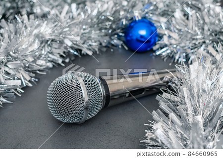 Microphone and decorations on a Christmas tree for a party Microphone and decorations on a Christmas tree for a party 84660965