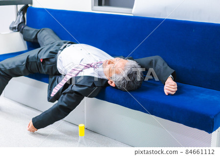 Middle-aged man lying on the train Middle-aged man lying on the train 84661112