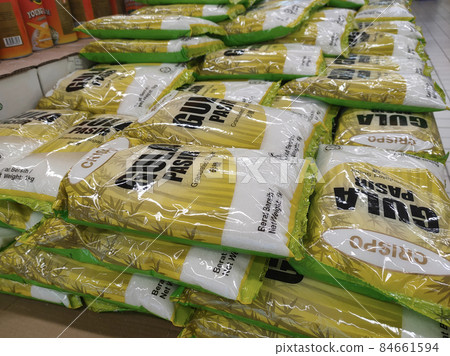 SELANGOR, MALAYSIA -JUNE 12, 2021: Selected focused on white sugar in commercial packaging is on display for sale in supermarkets. Sorted by brand and price tagged. 84661594