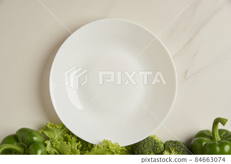 vegetable concept some green vegetables arranged at the bottom of white background vegetable concept some green vegetables arranged at the bottom of white background 84663074