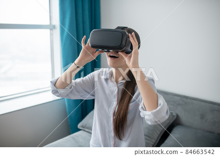 Female in VR glasses enjoying virtual reality 84663542