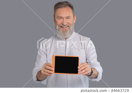 A man holding a tablet in hands 84663729
