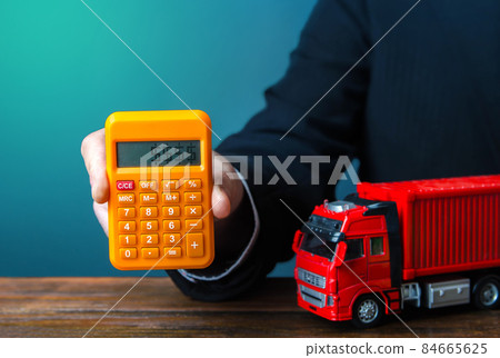 Businessman calculates the cost of shipping a container. Rising prices, global containers shortage crisis. Import and export. Cargo transit. Transportation inflation, shipping rates. Priced out 84665625