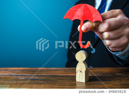 Insurance agent holds an umbrella over a men with a crack. Rehabilitation after trauma, drugs, alcohol. Health and life insurance. Psychological help. Social support. Recovery. Protectorate, patronage 84665628