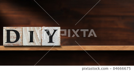 Text Diy made of Wooden Blocks above a Shelf with Copy Space Text Diy made of Wooden Blocks above a Shelf with Copy Space 84666675