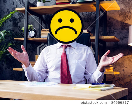 Business failure. Sad businessman with an emoticon instead of a face. Business failure. Sad businessman with an emoticon instead of a face. 84666817