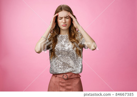 Caucasian woman feeling dizzy drink too much alcohol party, touching temples close eyes frowning suffering headache feeling discomfort, migraine, standing displeased unwell pink background Caucasian woman feeling dizzy drink too much alcohol party, touching temples close eyes frowning suffering headache feeling discomfort, migraine, standing displeased unwell pink background 84667385