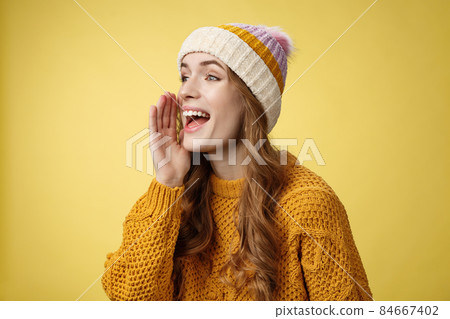 Attractive happy girlfriend shout call boyfriend standing far away take pic, turning left scream hold hand near opened mouth seek friend yelling loudly, search someone, yellow background Attractive happy girlfriend shout call boyfriend standing far away take pic, turning left scream hold hand near opened mouth seek friend yelling loudly, search someone, yellow background 84667402
