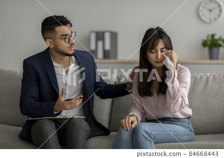 Upset arab lady with nervous breakdown consulting psychologist, crying while having session with counselor 84668443