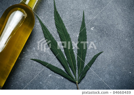 Cannabis oil cannabidiol. Medical cannabis marijuana and extract cbd on dark background. Cannabis oil cannabidiol. Medical cannabis marijuana and extract cbd on dark background. 84668489