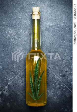 Cannabis oil cannabidiol. Medical cannabis marijuana and extract cbd on dark background. Cannabis oil cannabidiol. Medical cannabis marijuana and extract cbd on dark background. 84668523