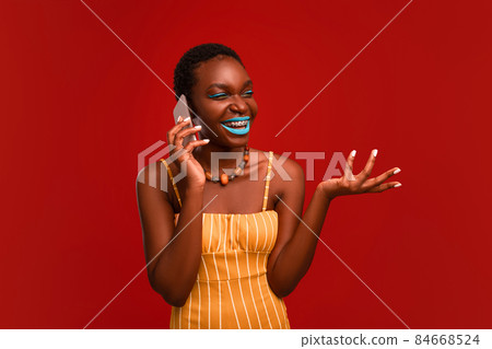 Happy african american woman having phone conversation Happy african american woman having phone conversation 84668524