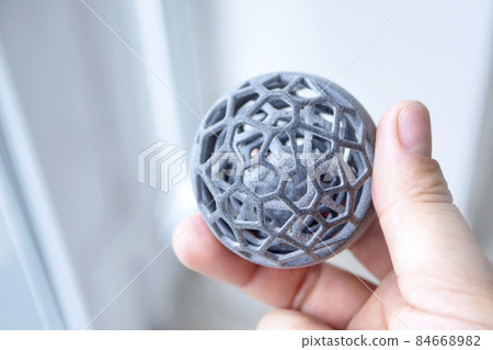 Man holding model printed on 3Dprinter. Creating model on industrial 3D printer 84668982