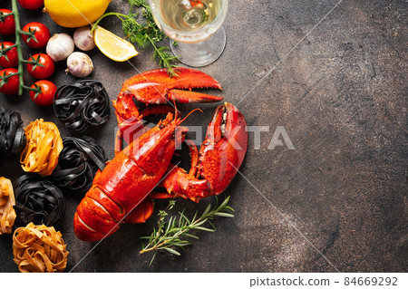 Food background with pasta, cooked lobster and wine Food background with pasta, cooked lobster and wine 84669292