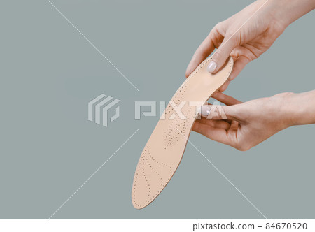 Orthopedic insole isolated on a white background. Medical insoles. Treatment and prevention of flat feet and foot diseases. Foot care, feet comfort. Wear comfortable shoes. Flat Feet Correction. Orthopedic insole isolated on a white background. Medical insoles. Treatment and prevention of flat feet and foot diseases. Foot care, feet comfort. Wear comfortable shoes. Flat Feet Correction. 84670520