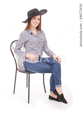 Beautiful young girl in black hat on his head 84671630