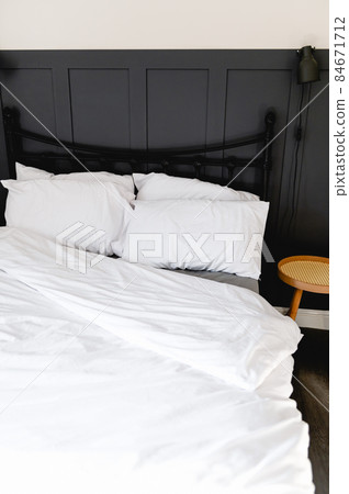 Soft pillows and duvet on comfortable bed Soft pillows and duvet on comfortable bed 84671712