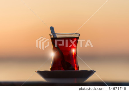 Traditional Turkish tea in a glass against the background of sunrise lights near Bosphorus 84671746