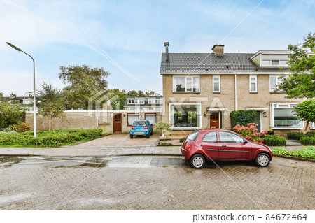 View of the facade of a two-story brick house 84672464