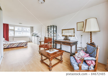 A cozy room with two antique armchairs 84672485