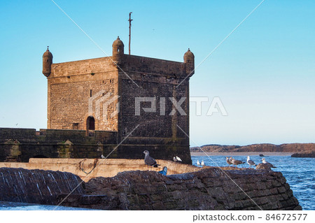 View of the old fortress of Essaouira on a sunny summer day at Essaouira, Morocco View of the old fortress of Essaouira on a sunny summer day at Essaouira, Morocco 84672577