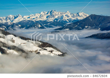 Winter landscape, stunning mountain range, snowy trees and blue sky at Maria Alm, Hinterthal in Austria 84672604