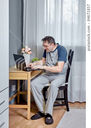 Presbyopia is an age related visual impairment, 52 year old man trying to read text on laptop screen. 84672857