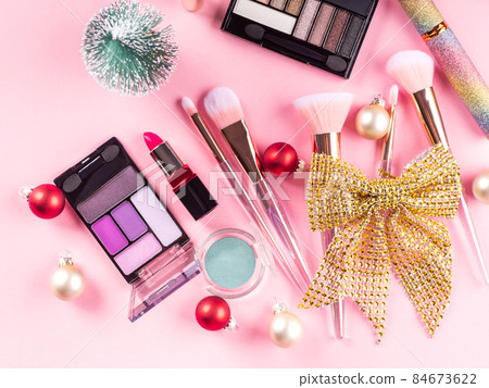 Christmas present with make up brushes, products on pink Christmas present with make up brushes, products on pink 84673622