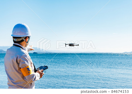 Workers operating drones 84674153