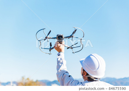 Workers flying drones Workers flying drones 84675590