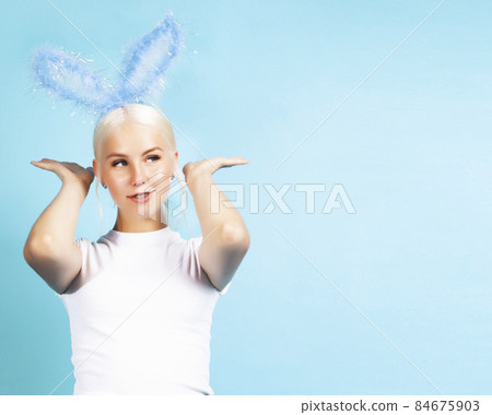 young pretty blond girl with rabbit ears posing cheerful on blue background, lifestyle people concept young pretty blond girl with rabbit ears posing cheerful on blue background, lifestyle people concept 84675903