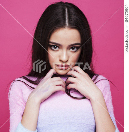 young pretty girl with brunette long hair posing cheerful on pink background, lifestyle people concept young pretty girl with brunette long hair posing cheerful on pink background, lifestyle people concept 84675904