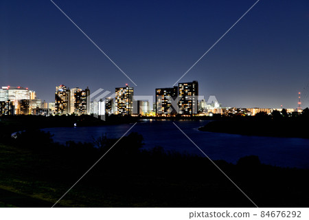 Night view of tower condominiums near Kawasaki Station seen from the bank of the Tamagawa River in Kawasaki City Night view of tower condominiums near Kawasaki Station seen from the bank of the Tamagawa River in Kawasaki City 84676292
