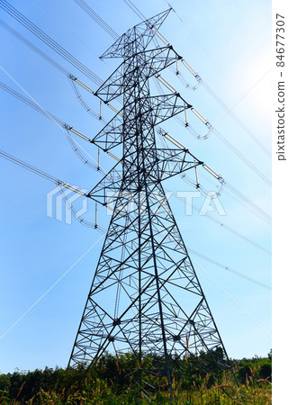 High voltage post, High voltage tower sky background on the mountain forest, Electricity poles and electric power transmission lines against countryside 84677307