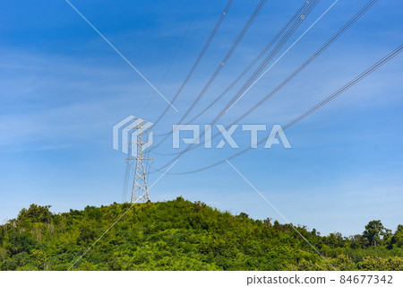 High voltage post, High voltage tower sky background on the mountain forest, Electricity poles and electric power transmission lines against countryside 84677342