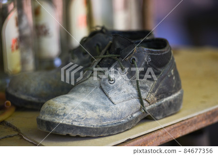 Old Boots, black shoes dirty on the shoe rack, military boots 84677356
