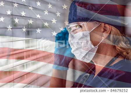 Stressed Female Doctor or Nurse On Break At Window Wearing Medical Face Mask and Goggles With Ghosted American Flag. 84679252