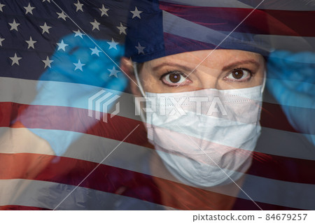 Doctor or Nurse Wearing Medical Face Mask and Scrubs with Ghosted American Flag. Doctor or Nurse Wearing Medical Face Mask and Scrubs with Ghosted American Flag. 84679257