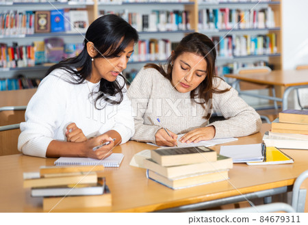 Two adult female students studying in university library Two adult female students studying in university library 84679311