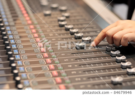 audio mixing console with hand of sound engineer 84679946
