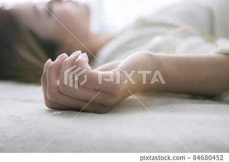 Female hands sleeping in a white bed 84680452