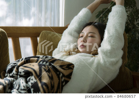 Tired woman lying on the couch Tired woman lying on the couch 84680657