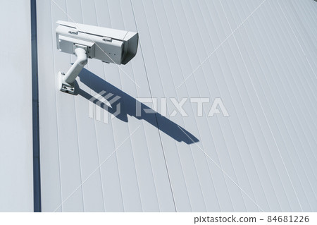CCTV camera on the wall of the building for monitoring and protection. CCTV camera on the wall of the building for monitoring and protection. 84681226