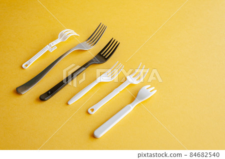 Range of forks. Various sort of forks on a yellow background. 84682540