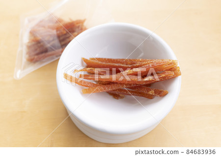 Dog scissors jerky in a white plate 84683936
