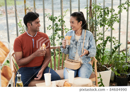 Couple Eating Sandwiches Outdoors 84684990