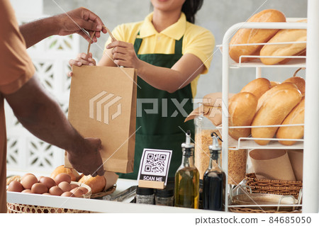 Bakery Worker Giving Package to Courier Bakery Worker Giving Package to Courier 84685050