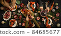 People feasting with chicken and hot wine at 84685677