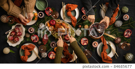 People feasting with chicken and hot wine at 84685677