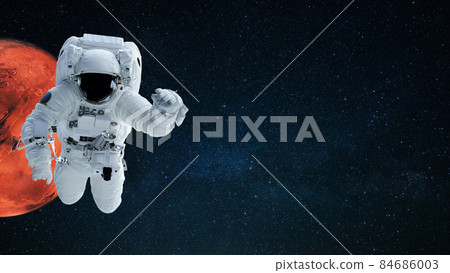 Space man in space suit flies in starry space with red planet mars, copy space for text and design. Cosmos wallpaper Space man in space suit flies in starry space with red planet mars, copy space for text and design. Cosmos wallpaper 84686003